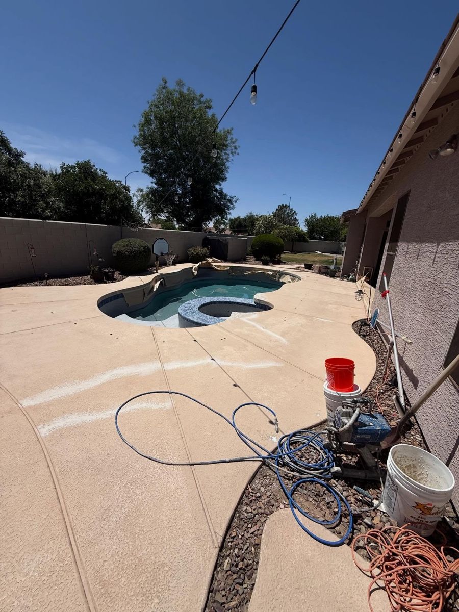 Pool deck with sprayer and buckets mid-job