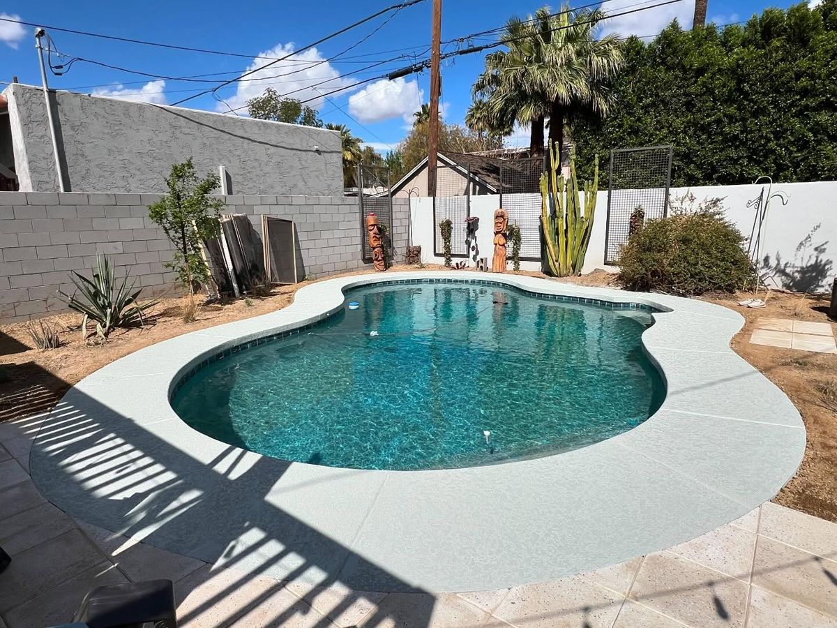 Sage gray pool deck with tiki carvings and cactus