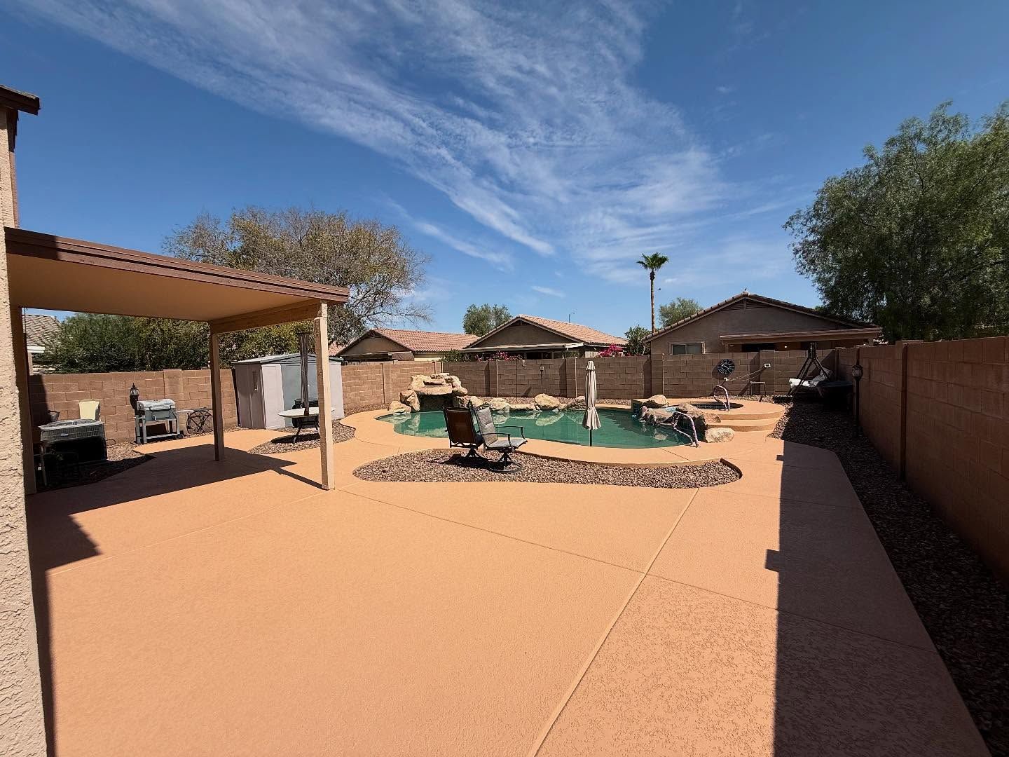 Terracotta deck with rock waterfall and pergola